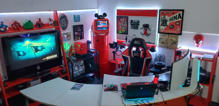 Espaço dos alunos com computadores e cadeiras gamer